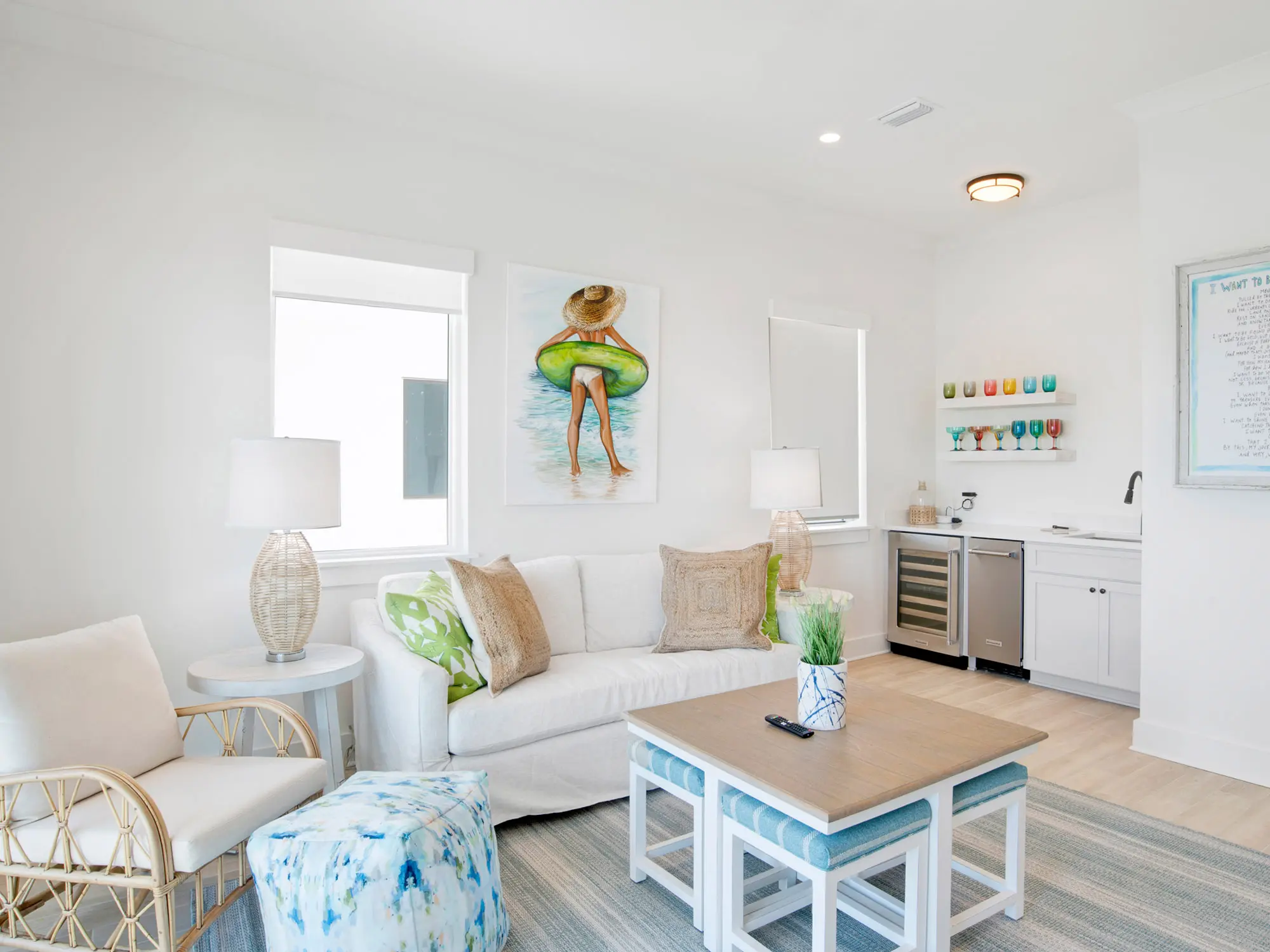 Bright living room with beach-themed decor and playful wall art.